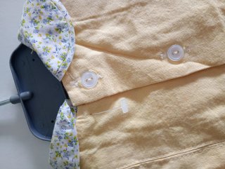 Pelele de bebé amarillo con cuello floral