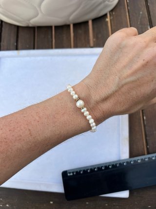 Pulsera de perlas blancas y detalles dorados