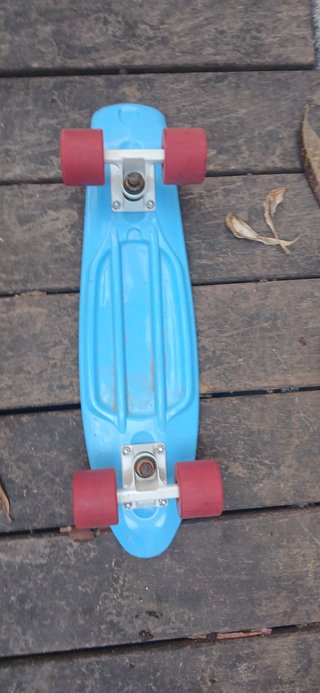 Skate azul con ruedas rojas