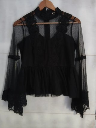 Blusa negra de encaje con volantes.