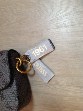 Bolso de marca gris con detalles dorados