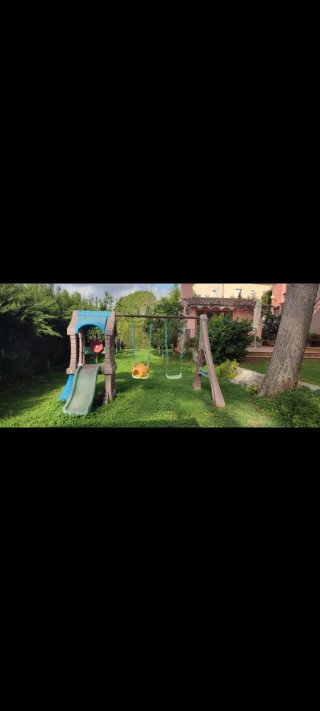 Parque infantil columpios, tobogán y caseta
