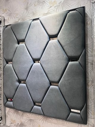 Cabecero de tela gris con detalles plateados