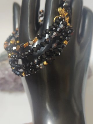 Bracciale rigido biconi neri e oro