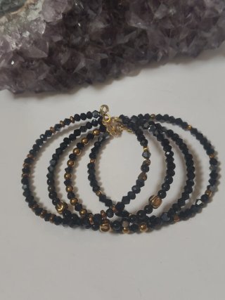Bracciale rigido biconi neri e oro