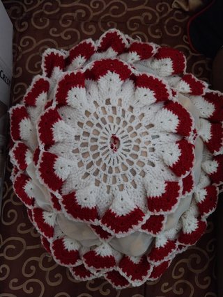 Almofada com capa feita em croché vermelho e branc