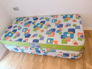 Sofá modular beige con mesa de cristal y cama
