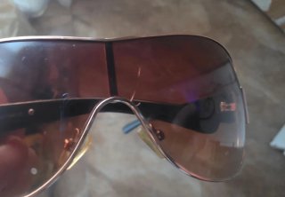 Gafas de sol Prada negras y doradas