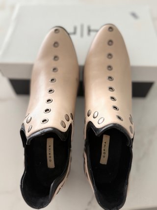 Botín beige con tachuelas y detalles negros