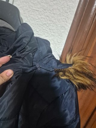 Chaqueta acolchada azul con capucha de pelo