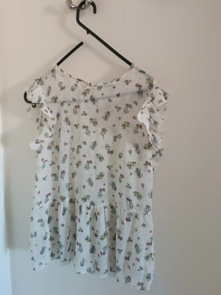 Blusa blanca con volantes y estampado floral