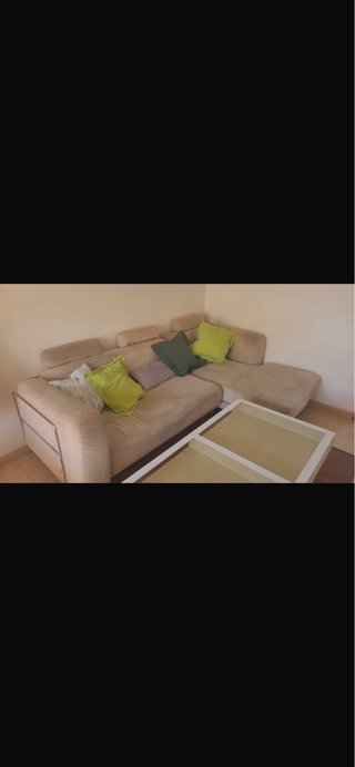 Sofá modular beige con cojines verdes