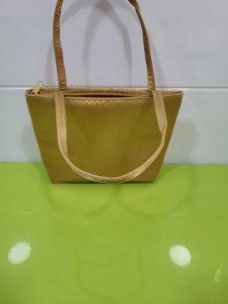 Bolso de mano beige y dorado tejido con cuentas