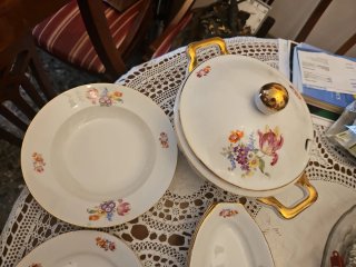 Vajilla de porcelana con borde dorado.