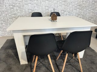 Mesa blanca con 4 sillas negras