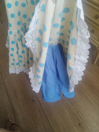 Traje de flamenca beige con lunares azules.