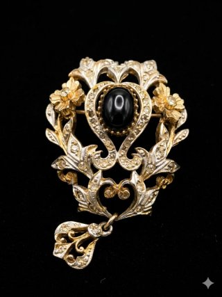 Spilla vintage con pietra nera e dettagli oro