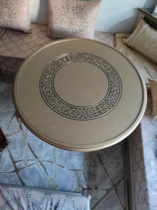 Mesa auxiliar dorada con detalles ornamentales