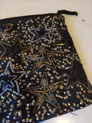 Neceser Stradivarius estrellas negro y dorado