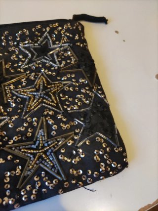 Neceser Stradivarius estrellas negro y dorado