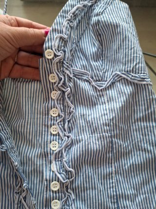 Blusa de rayas azules y blancas con volantes