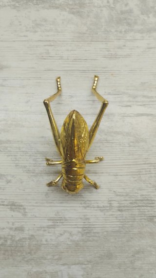 Saltamontes Zara Home metal dorado