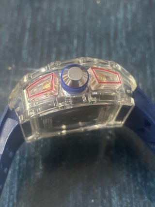 RM con correa azul y caja transparente, repararrep