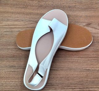 Sandalias blancas slip-on de mujer.