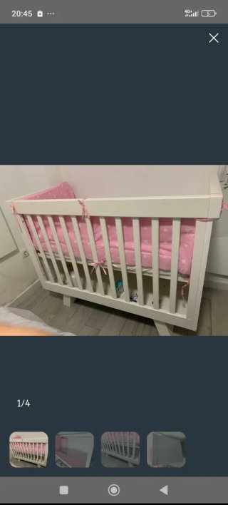 Cuna de bebé blanca con detalles rosas