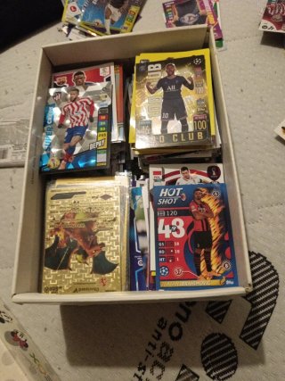 Caja de repleta de cromos de fútbol y Pokémon