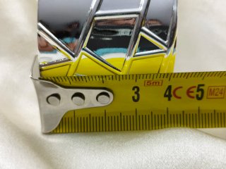 Brazalete laminada en plata con detalles dorados.