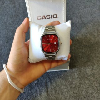 Reloj Casio plateado y dial rojo