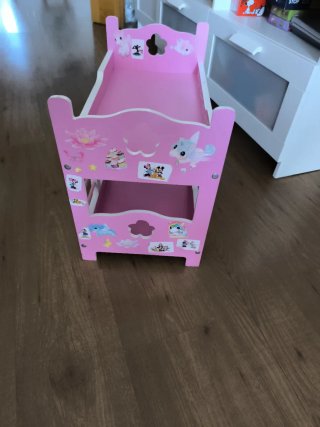 Cuna de juguete rosa para muñecas. Juguetos