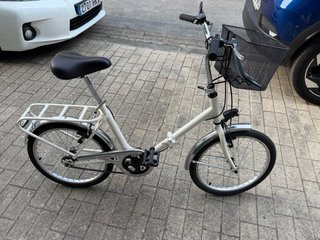 Bicicleta plegable blanca con cesta