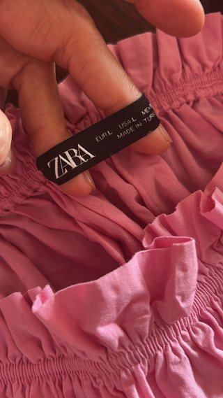 Top rosa con volantes