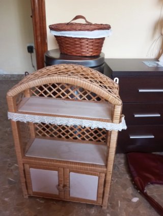Mueble de mimbre con puertas y estantes.