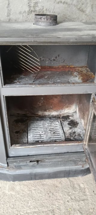 Estufa de leña de hierro gris con horno