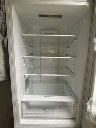 Nevera con estantes de cristal Y congelador.