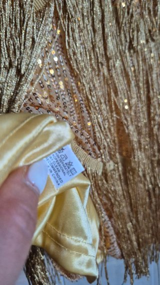 Top oro con frange e paillettes