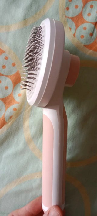 Cepillo autolimpiante para perros y gatos rosa