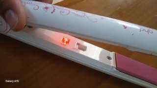 Plancha de pelo ghd rosa y blanca