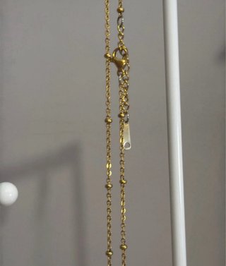 Collar dorado con colgante de globo terráqueo