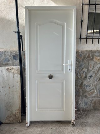 Puerta de entrada blanca con pomo
