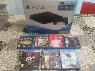 PS4 con un mando, caja y 7 juegos
