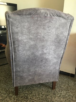 Sillón orejero gris de tela