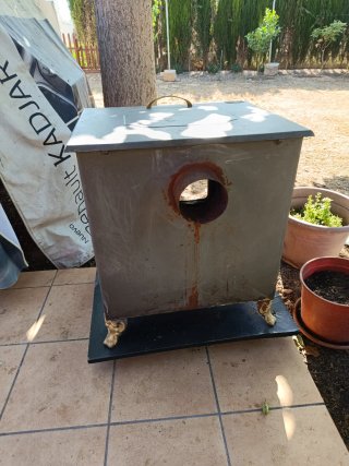 Estufa de leña metálica con puerta de cristal
