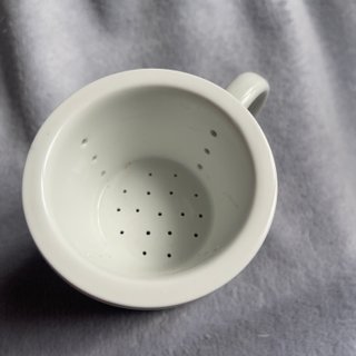 Taza de té oriental con colador