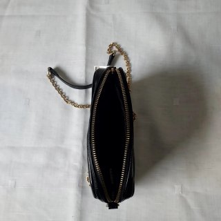 Bolso negro brillante de hombro con cadena dorada