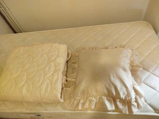 Colcha beige con cojín