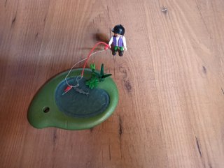 Figura pescador en lago